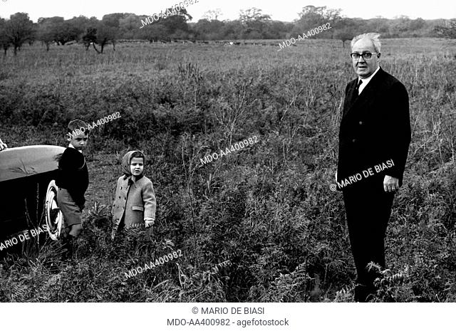 The President of the Italian Republic Giuseppe Saragat postng on the grass with his Italian grandchildren Augusto Santacatterina and Giuseppina Santacatterina