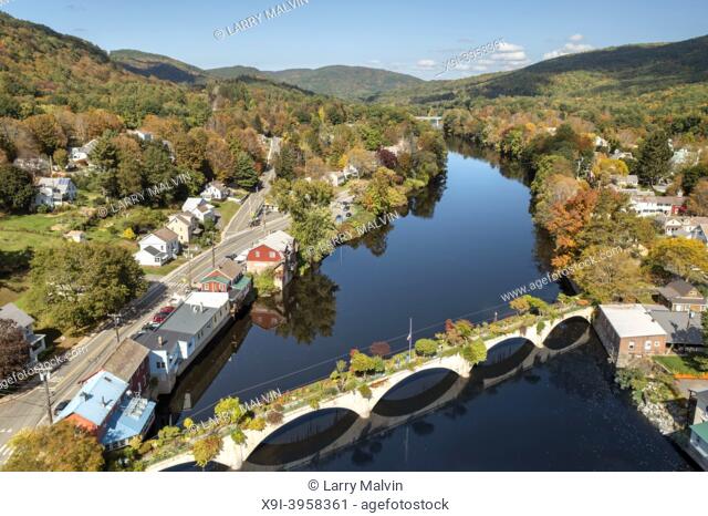 The Bridge of Flowers spans the Deerfield River with the rolling hills of Western Massachusetts as a backdrop in Shelburne, MA during fall