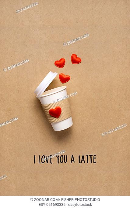Creative concept photo of take away coffee cup with hearts on brown background