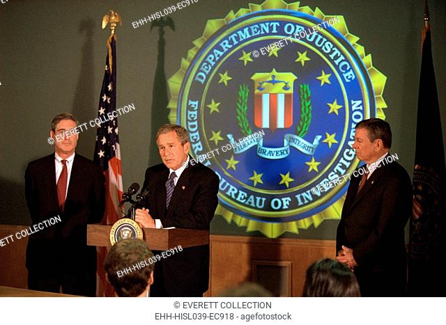 President George W. Bush at FBI Headquarters, Sept. 25, 2001. He is flanked by Director Robert Mueller, left, and U.S. Attorney General John Ashcroft