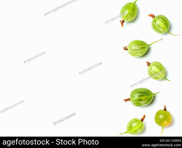 Heap of ripe green gooseberry berries on white background. Creative layout made of organic gooseberries. Isolated on white with clipping path