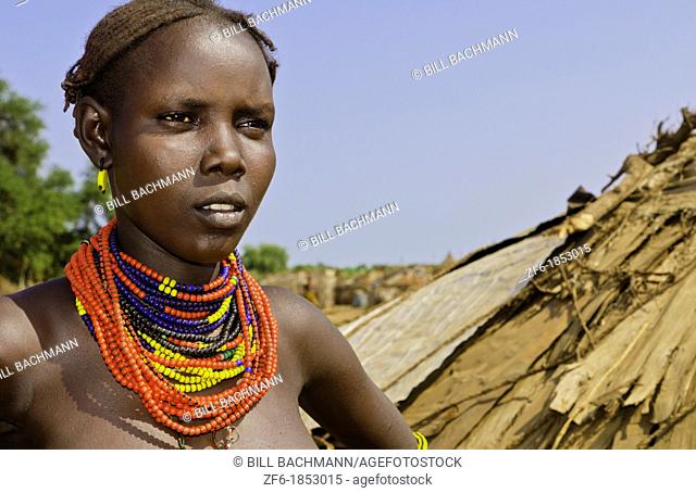 Dassnech tribe in Omorate in Ethiopia Africa in Lower Omo Valley with tribal woman Dassnech topless breasts hut 26