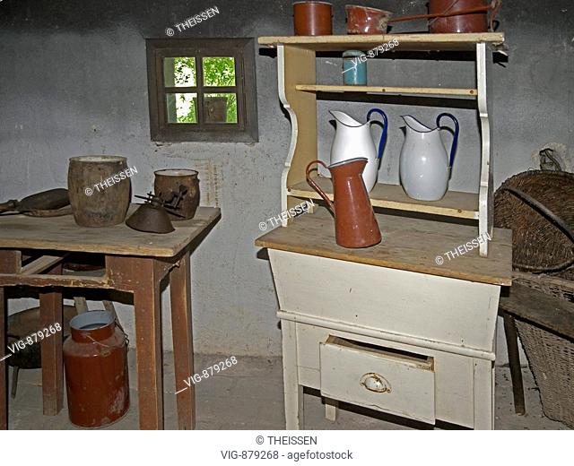interior view from an old kitchen in a cottage farmhouse room with table and cupboard in the flower park Mozirski Gaj in the town Mozirje in the in the valley...