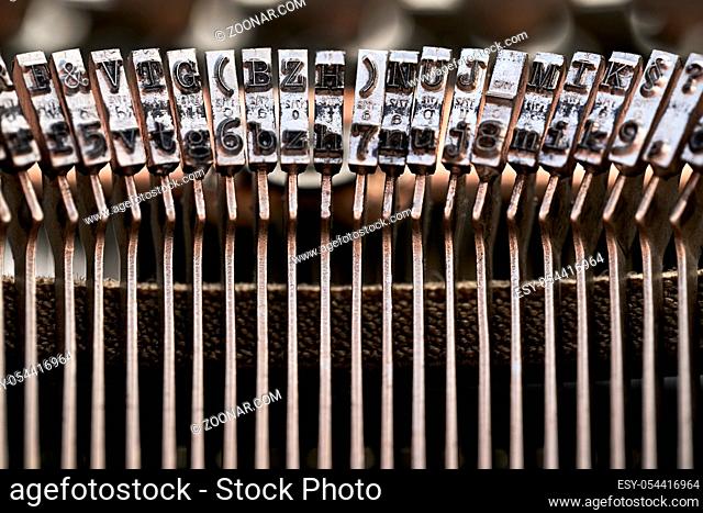 Amazing macro photo of typebars of a retro typewriter in the studio. Horizontal