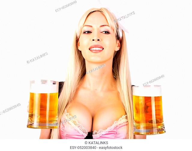 Young beautiful blond oktoberfest woman with big neckline on female breast Holds two mugs with light beer