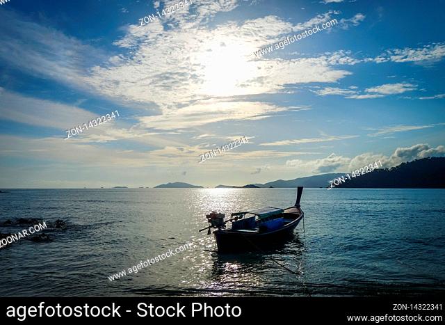 Tropical beach and boat at sunset in Koh Lipe, Thailand