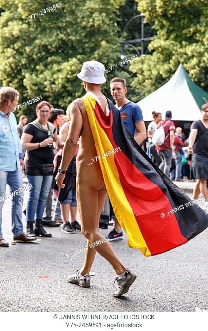 Berlin, Germany - June 27, 2015: Nude man with German flag cape on Christopher Street Day 2015 in the streets of Berlin, Germany