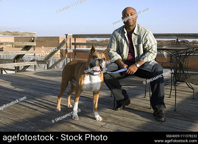 African man and dog on deck - dogs