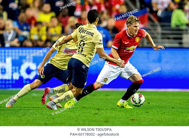 Manchester United's Bastian Schweinsteiger competes for the ball against Club America's Andres Andrade during the soccer friendly match between Manchester...