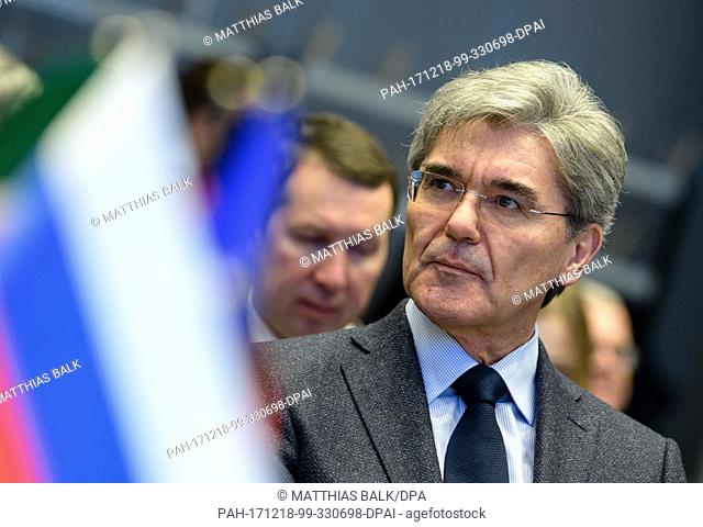 Joe Kaeser, Chairman of the Board of Siemens, sitting behind a Russian flag during the signing of an agreement between the German company Siemens Russia and...