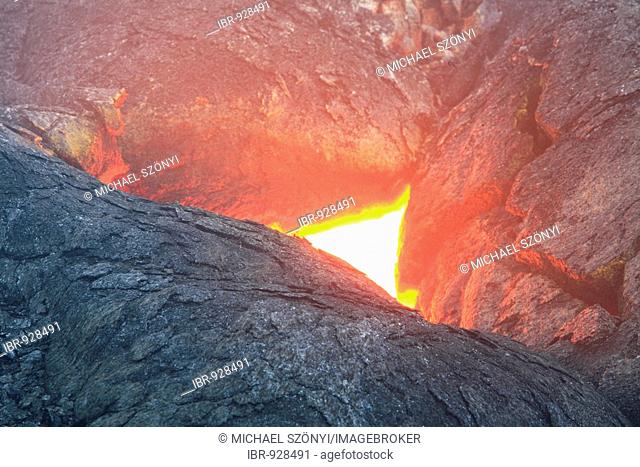 A so-called Skylight, where you can see the still flowing molten lava under the solidified lava, Eastern Rift Zone, Kilauea volcano, Kalapana, Big Island