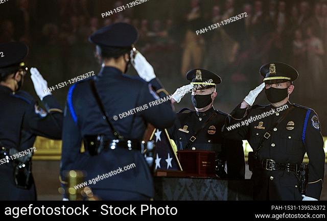 WASHINGTON, DC - FEBRUARY 3: .U.S. Capitol Police Officers salute as they change the guard before a ceremony memorializing U.S