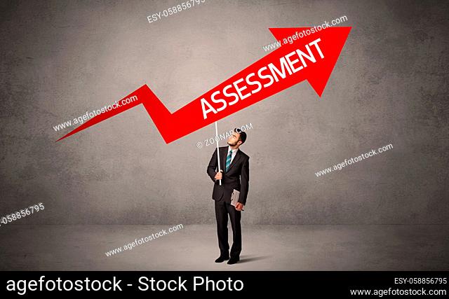 Young business person in casual holding road sign with ASSESSMENT inscription, business direction concept