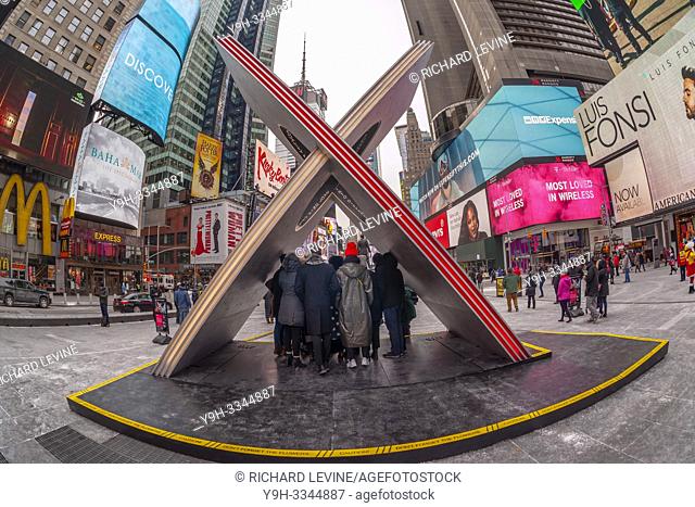 Tourists and the media crowd "X", the winner of the Times Square Valentine Heart Design in Times Square in New York, at its unveiling on Friday, February 1