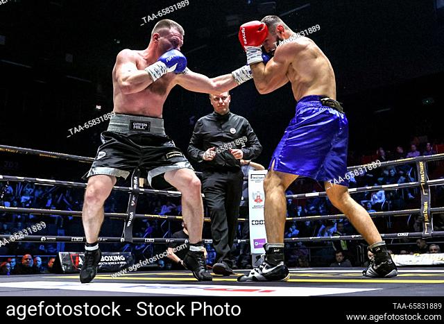 RUSSIA, MOSCOW - DECEMBER 16, 2023: Boxers Maxim Smirnov (L) of Russia and Leon Antonyan of Russia fight in a boxing bout as part of the IBA Champions' Night at...