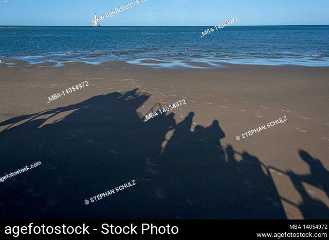 france, nouvelle-aquitaine, gironde department, le verdon-sur-mer, the shadows of tourists on an amphibious vehicle in the estuary of the gironde river
