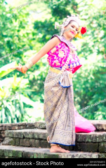 Asian woman wearing typical, traditional Thai Dress. It is literally means ""Thai outfit"", National costume.