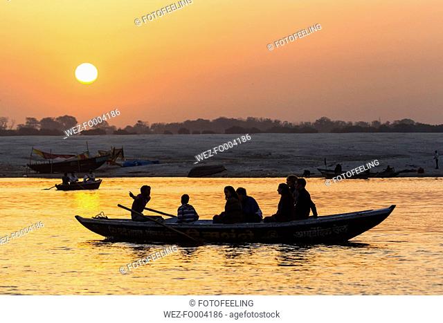 India, Uttar Pradesh, Banaras, Tourist at River Ganges during sunrise