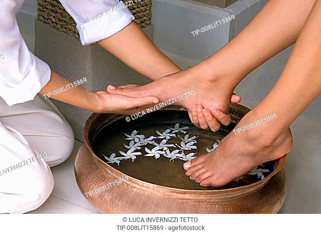 Woman getting a floral foot bath