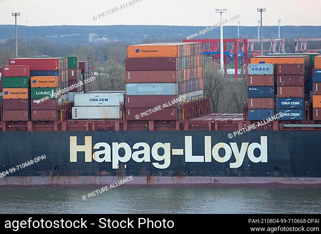 14 April 2021, Hamburg: Stacked containers stand on the container ship Al Jmeliyah of the shipping company Hapag-LLoyd in the evening