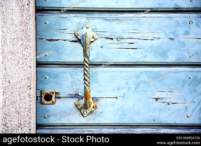 cross lombardy  arsago seprio abstract  rusty brass brown knocker in a door curch closed wood italy
