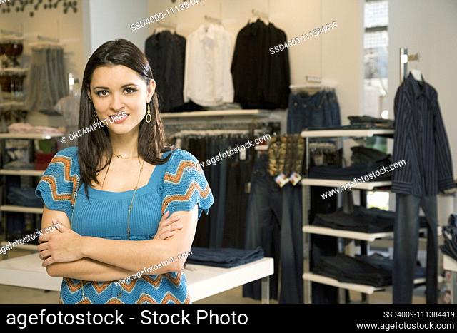 Mixed race woman standing in clothing shop