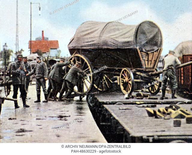 A contemporary German colorized propaganda photo shows loading a pack wagon onto a train to be transported to the front, date and location unknown (1914-1918)