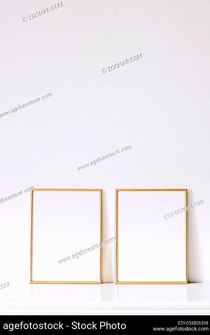 Two golden vertical frames on white furniture, luxury home decor and design for mockup creations