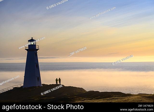 Visitors at Cape Spear Lighthouse with fog bank over the Atlantic Ocean; St. John's, Newfoundland, Canada