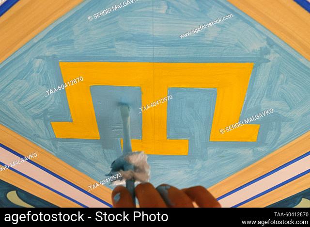 RUSSIA, SIMFEROPOL - JULY 12, 2023: An artist paints the dome of the Great Friday Mosque; artists from Russia and Turkey are taking part in the dome painting