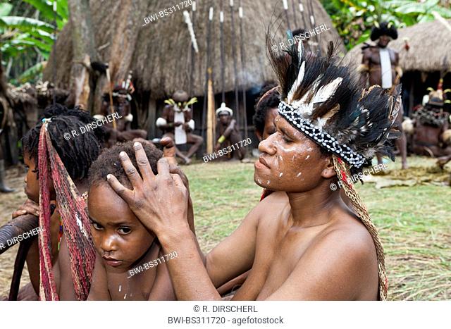 , Dani women and girls lousing, Indonesia, Western New Guinea, Baliem Valley