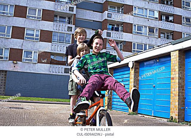 Boy giving friends a ride on bike