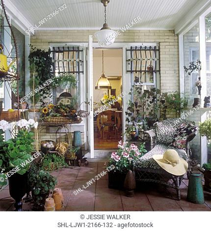 PORCHES: Very creative, garden room, wicker chaise lounge, architectural accents, ceramic tile floor, potted plants and flowers