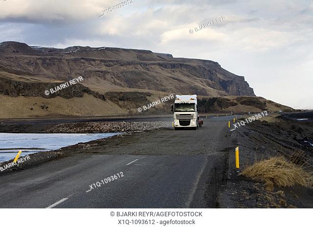 Truck driving over Markarfljot glacial river which flooded during the volcanic eruption in Eyjafjallajokull glacier, South Iceland  Road workers managed to dig...