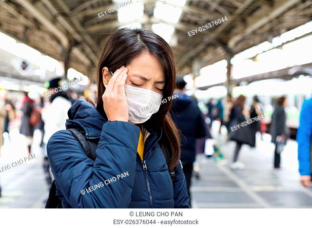 Woman feeling unwell in train station