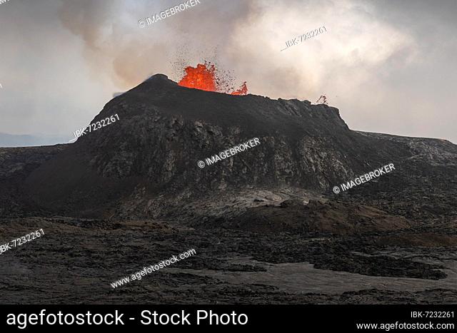 Lava fountain spraying from crater, cooled lava flows, active table volcano Fagradalsfjall, Krýsuvík volcanic system, Reykjanes Peninsula, Iceland, Europe