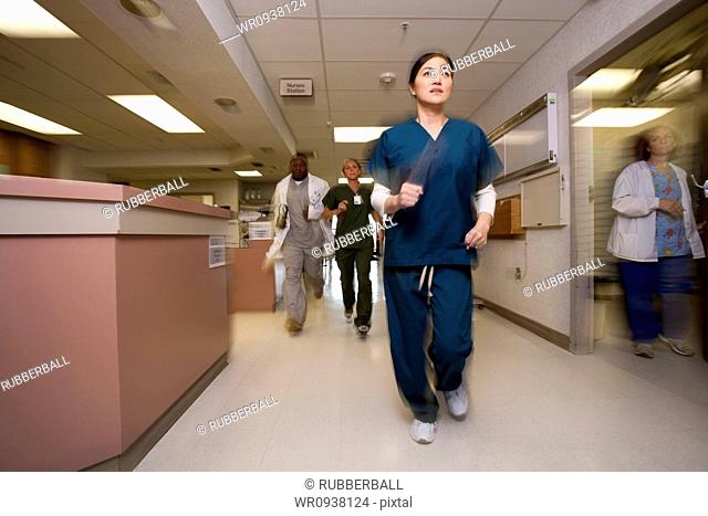 Doctor and nurses rushing through corridor