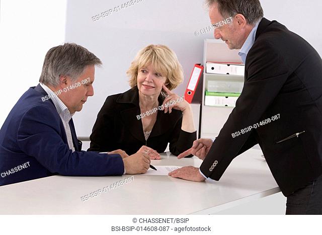 Couple signing a document