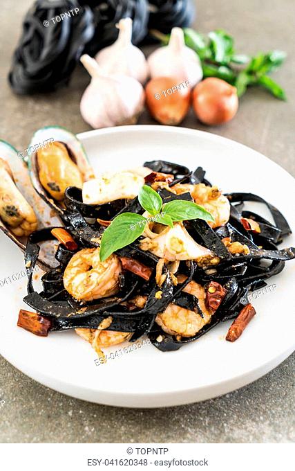 black spaghetti or pasta with seafood on plate