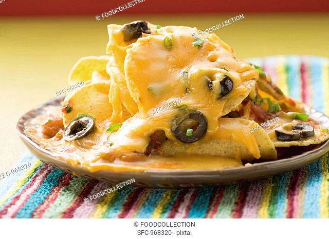 Tortilla chips with melted cheese and olives Mexico