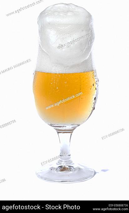 Close view of a glass of beer isolated on a white background
