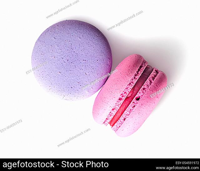 Two macaroon purple pink top view on white background