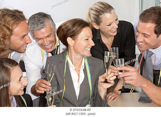 Happy businesspeople drinking champagne together