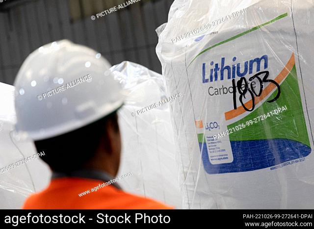 25 October 2022, Chile, Antofagasta: A worker stands in front of a bag of lithium carbonate in a warehouse of the Chilean company SQM