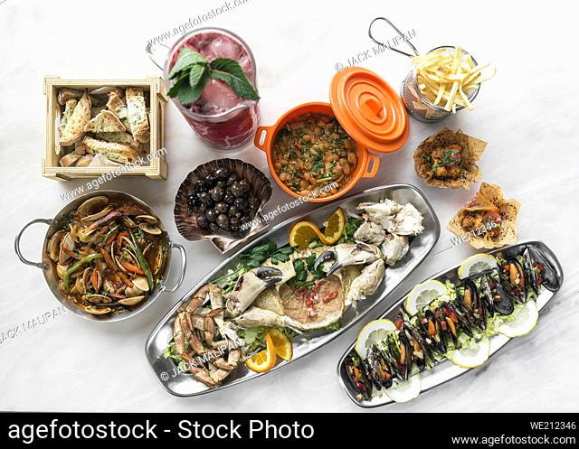 mixed spanish gourmet tapas sharing set selection on restaurant table in barcelona