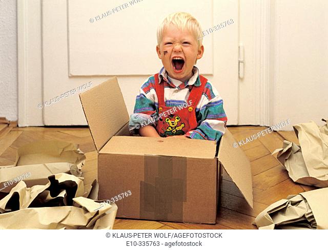 2 year old boy in a box crying