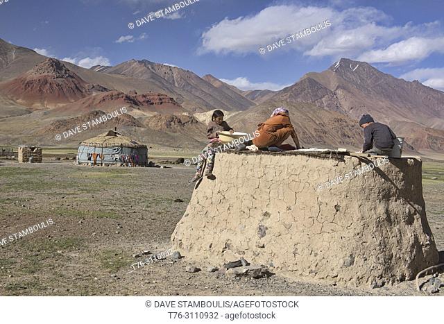 Kyrgyz herding family making kaiymak cheese in the Pshart Valley, Tajikistan