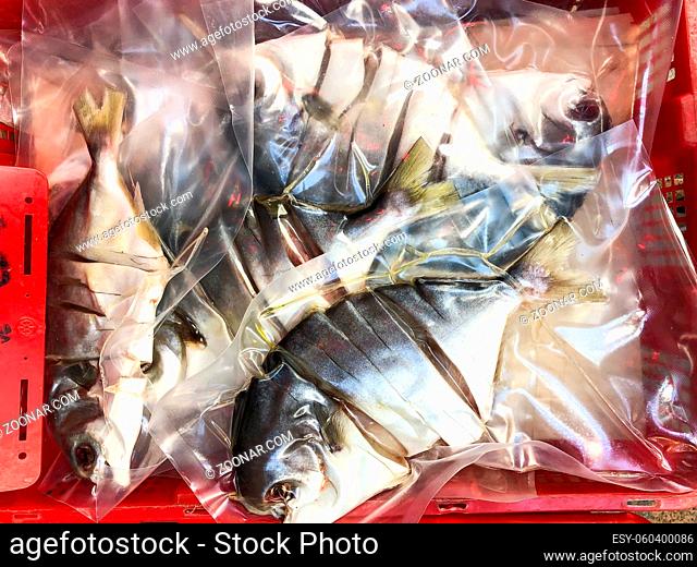 sliced fish in plastic for sale on market, Hong Kong -