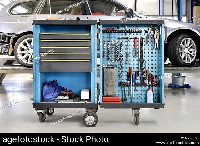 Tools on a trolley, organised in rows, at an auto repair shop