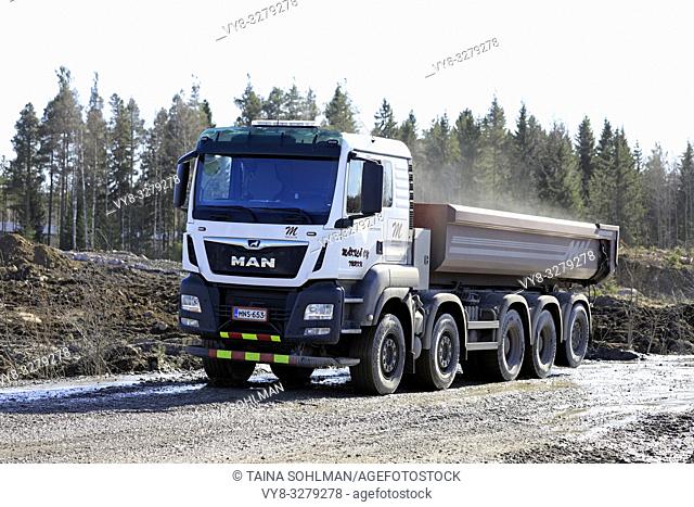 Lieto, Finland - March 22, 2019: White MAN TGS 45. 500 tipper truck of Makila Oy at work on a construction site on a sunny day of spring